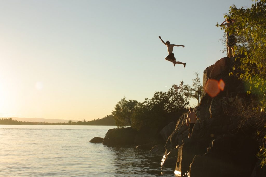 Person leaping from rocks