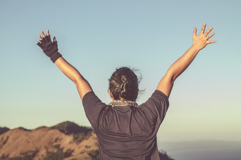 Woman reaching hands into air