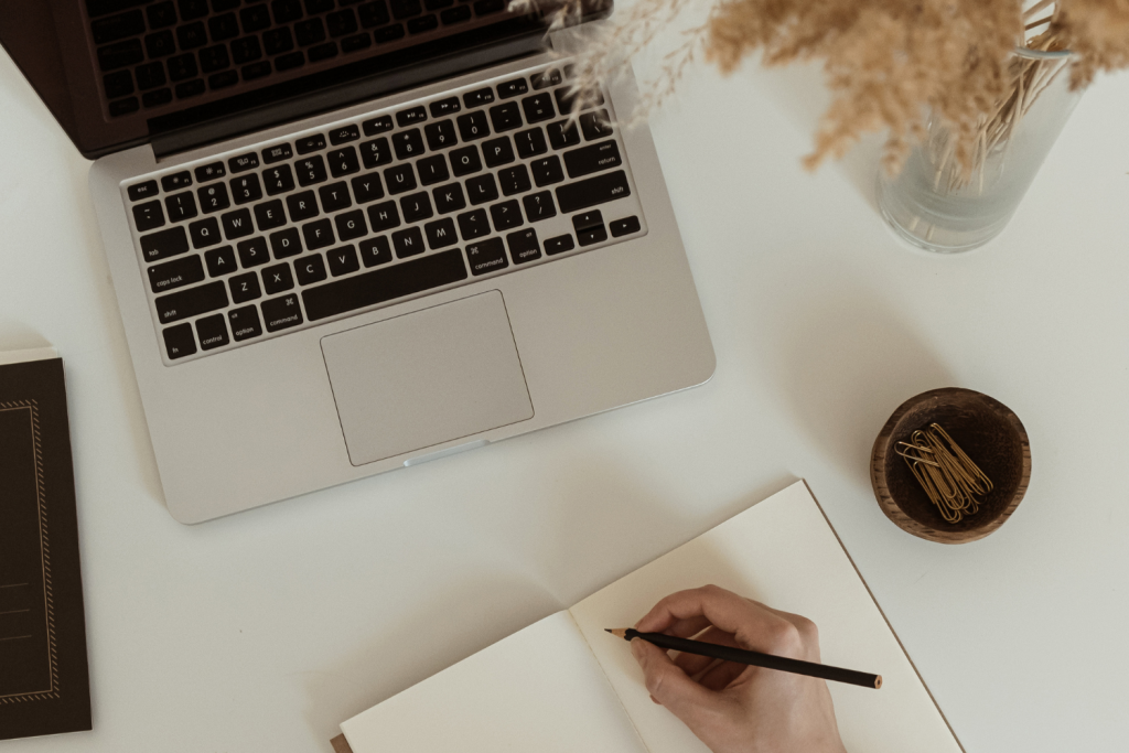 Laptop, Person writing, Drinks and flowers
